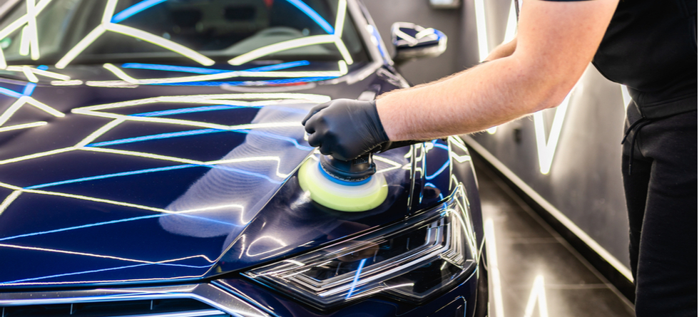 A guy Detailing exterior of a car