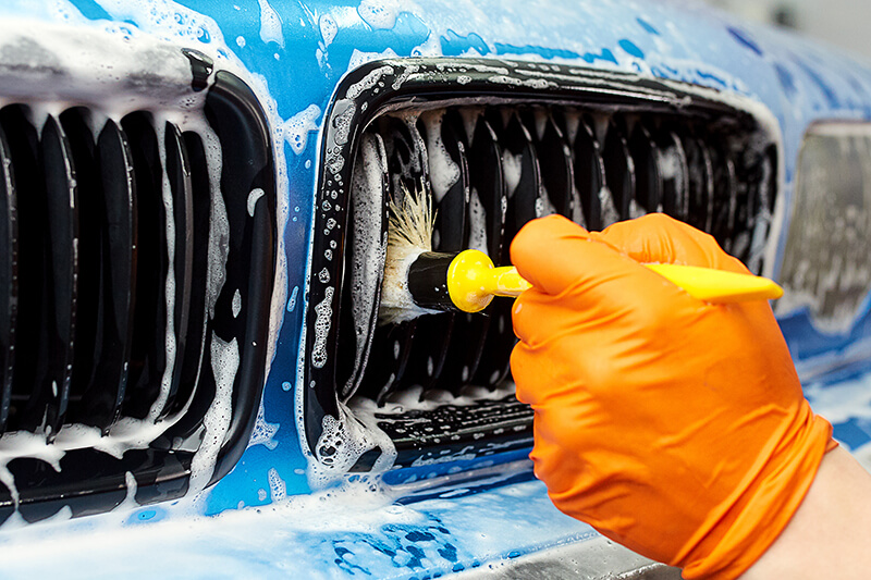 Blue cars front being detailed.